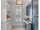 Chic laundry room featuring modern washer/dryer and custom navy blue and white shelving at 3699 Goodwater St, Mount Pleasant, SC 29466