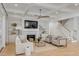 Spacious living room with coffered ceiling, fireplace, built-in shelving, and hardwood floors at 3699 Goodwater St, Mount Pleasant, SC 29466