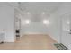 Open-concept living area with vaulted ceilings, light wood floors, and a doorway to the laundry room at 3699 Goodwater St, Mount Pleasant, SC 29466