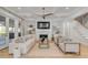 Inviting living room with custom built-ins, a cozy fireplace, and hardwood flooring at 3699 Goodwater St, Mount Pleasant, SC 29466