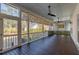 Covered porch with ceiling fans, wood floors, and views of the surrounding trees at 3699 Goodwater St, Mount Pleasant, SC 29466