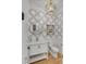 Elegant powder room with modern fixtures, decorative wallpaper, and stylish gold-toned mirror at 3699 Goodwater St, Mount Pleasant, SC 29466