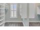 Well-organized walk-in closet with custom shelving and a window with shutter at 3699 Goodwater St, Mount Pleasant, SC 29466