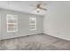 Bright bedroom featuring neutral carpeting, ceiling fan and two windows for optimal natural light at 4722 Whitwil Blvd, North Charleston, SC 29418