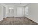 This bedroom includes neutral carpet, a ceiling fan, natural light, built-in vanity with storage and closet space at 4722 Whitwil Blvd, North Charleston, SC 29418