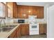 Well-organized kitchen featuring wood cabinets, white appliances, and linoleum flooring at 4722 Whitwil Blvd, North Charleston, SC 29418