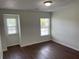 This naturally lit bedroom showcases two windows and hardwood floors at 4804 Coopers Ct, Summerville, SC 29485