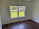 Bright bedroom with hardwood floors and a window that overlooks the backyard at 4804 Coopers Ct, Summerville, SC 29485
