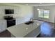 Bright kitchen with stainless appliances, a large island, and a view of the backyard at 4804 Coopers Ct, Summerville, SC 29485