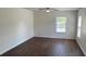 Spacious living room with ceiling fan and hardwood floors, illuminated by natural light from many windows at 4804 Coopers Ct, Summerville, SC 29485