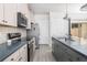 Modern kitchen with stainless steel appliances and a large island and gray plank flooring at 5146 Park Creek Ave, North Charleston, SC 29418