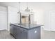 Kitchen with gray island, gray plank floors, and views to dining and living room at 5146 Park Creek Ave, North Charleston, SC 29418