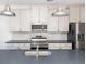 A kitchen with modern appliances and fixtures, light colored cabinets, and gray countertops at 5146 Park Creek Ave, North Charleston, SC 29418