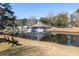 Scenic view of a pond featuring a pavilion with a fountain and a serene park-like setting for leisure at 5146 Park Creek Ave, North Charleston, SC 29418