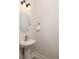 Pedestal sink in the powder room with accent mirror, light fixture and hand towel at 5146 Park Creek Ave, North Charleston, SC 29418