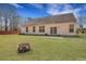 Home featuring a large, grassy backyard with a fire pit at 5420 Percival Ln, North Charleston, SC 29420