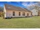 Home featuring a large, grassy backyard with a patio area at 5420 Percival Ln, North Charleston, SC 29420