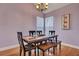 Cozy dining room featuring hardwood floors, a chandelier, a table with bench seating, and lots of natural light at 5420 Percival Ln, North Charleston, SC 29420