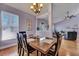Cozy dining room features wood table, light fixture, and serene lilac walls at 5420 Percival Ln, North Charleston, SC 29420