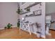 Airy entryway featuring light purple walls, hardwood floors, and decorative shelving with lush plants at 5420 Percival Ln, North Charleston, SC 29420