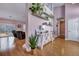 Inviting entryway with hardwood floors, light purple walls, decorative shelving, and open access to living areas at 5420 Percival Ln, North Charleston, SC 29420