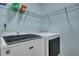 Practical laundry room with modern washer and dryer and storage shelving at 5420 Percival Ln, North Charleston, SC 29420