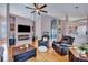 Open-concept living room featuring hardwood floors, comfortable seating, and views into the dining area at 5420 Percival Ln, North Charleston, SC 29420