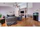 Spacious living room featuring hardwood floors, a TV over a modern fireplace, and comfortable furnishings at 5420 Percival Ln, North Charleston, SC 29420