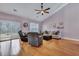 Vaulted ceiling living room with hardwood floors, slider door access to outdoors, and cozy seating at 5420 Percival Ln, North Charleston, SC 29420
