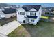 Aerial view of a two story home with a dark roof, long driveway, and fenced in yard at 615 Ravens Wood Rd, Summerville, SC 29486