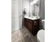 Bathroom features a toilet and vanity with dark wood cabinets, a white countertop, and gray tile flooring at 615 Ravens Wood Rd, Summerville, SC 29486