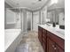 Ensuite bathroom with double vanity, walk-in shower, and a separate tub at 615 Ravens Wood Rd, Summerville, SC 29486