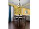 Bright dining area features a modern chandelier, dark wood floors, and stylish wall art at 615 Ravens Wood Rd, Summerville, SC 29486