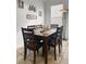 Dining room with a large window and a six-chair wood dining set at 615 Ravens Wood Rd, Summerville, SC 29486