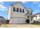 Inviting two-story home featuring an attached two-car garage and a classic design with black shutters at 615 Ravens Wood Rd, Summerville, SC 29486