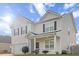 Charming two-story home showcasing a well-manicured lawn and inviting front porch at 615 Ravens Wood Rd, Summerville, SC 29486