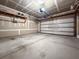 Spacious unfinished garage with concrete floor and walls and a white garage door at 615 Ravens Wood Rd, Summerville, SC 29486