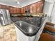Kitchen boasts granite countertops, stainless steel appliances, and breakfast bar with barstools and wooden cabinetry at 615 Ravens Wood Rd, Summerville, SC 29486