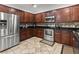 The kitchen features stainless appliances, dark cabinetry, and a decorative tile backsplash at 615 Ravens Wood Rd, Summerville, SC 29486