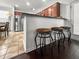 Modern kitchen features stainless steel appliances, stylish bar stools, and a granite countertop breakfast bar at 615 Ravens Wood Rd, Summerville, SC 29486