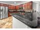 An eat-in kitchen with stainless appliances, dark cabinets, granite counters, and a tiled backsplash at 615 Ravens Wood Rd, Summerville, SC 29486