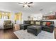 Cozy living room features hardwood floors, ceiling fan, a sectional sofa, and beautiful decor at 615 Ravens Wood Rd, Summerville, SC 29486
