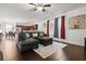 The living room is open to the kitchen, featuring a ceiling fan and an ornate rug at 615 Ravens Wood Rd, Summerville, SC 29486