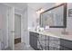 Bathroom featuring double sink vanity with grey cabinets, quartz countertop, and a large mirror at 625 Sienna Way, Summerville, SC 29486