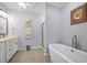 Bathroom with a single sink, stand alone bathtub, and glass shower at 625 Sienna Way, Summerville, SC 29486