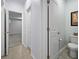Neutral-toned bathroom with tile flooring, open door to the toilet, and another leading to a carpeted area at 625 Sienna Way, Summerville, SC 29486