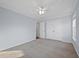 Well-lit bedroom with neutral carpet, large closet, and a ceiling fan at 625 Sienna Way, Summerville, SC 29486