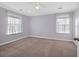 Empty bedroom featuring neutral carpet and two windows with sheer curtains at 625 Sienna Way, Summerville, SC 29486