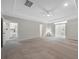 Large bedroom with neutral carpet, ceiling fan, and view to the laundry room at 625 Sienna Way, Summerville, SC 29486