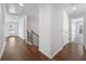 Hallway features hardwood floors, staircase, and view to front porch at 625 Sienna Way, Summerville, SC 29486